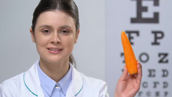 Cute Nurse Showing Carrot at Camera, Healthy Dieting Recommendation, Vitamins