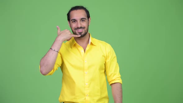 Young Happy Bearded Indian Businessman with Call Me Gesture