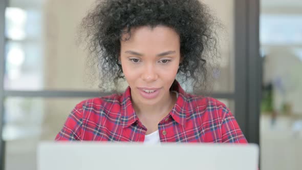 Close Up of African Woman Celebrating Success on Laptop