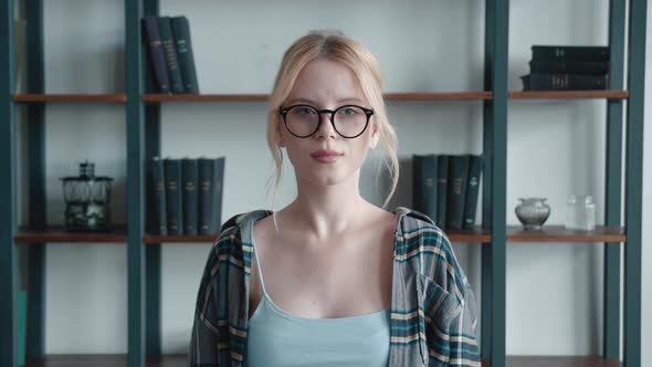 Closeup of Surprised Excited Blonde Young Woman in Checkered Shirt and Glasses Opening Her Mouth in