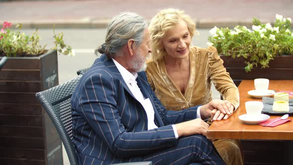 Elderly Couple Sitting at the Table