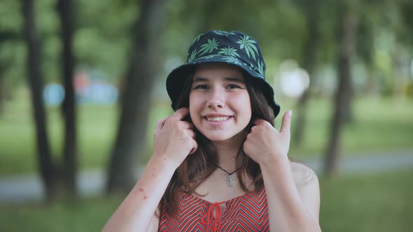 Portrait of a Teenage Girl in a Panama Hat in a Park in the Summer