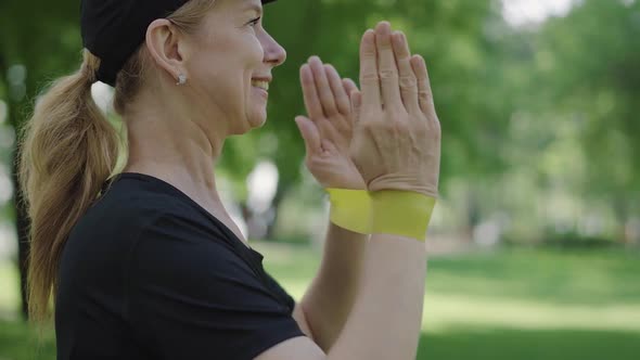 Close-up Side View of Confident Cheerful Sportswoman Exercising with Resistance Band Outdoors