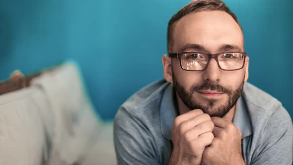 Portrait of Bearded Guy in Glasses Lying on Couch