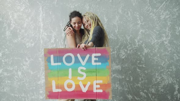 Female Lesbian Couple Holding Colorful LGBT Poster
