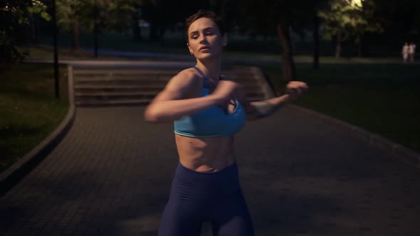 Athletic Girl Doing Stretching in the Evening Park