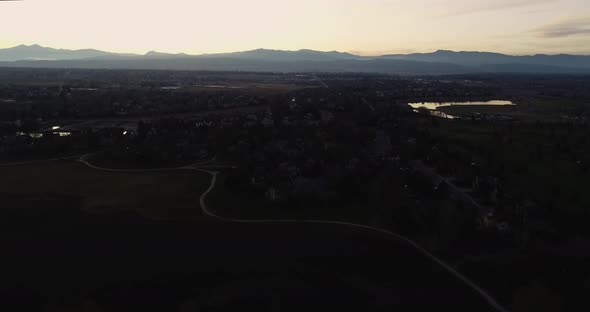 Rocky mountain sunset from a drone over a suburban neighborhood,  4k 60fps. drone