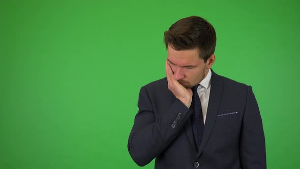 A Young Handsome Businessman Acts Sad - Green Screen Studio