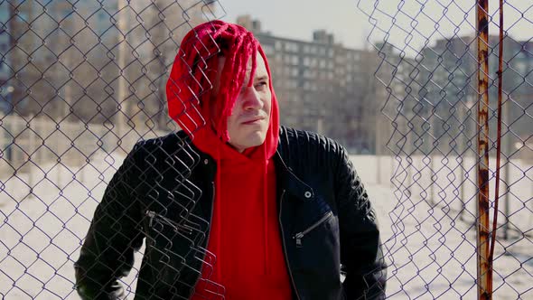 Stylish Man in Trendy Outfit and with Red Dreadlocks Standing on Street