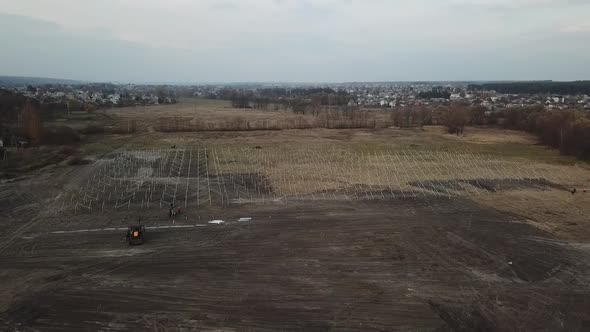 Stunning Aerial View of a Field with the Construction of a Solar Power Station