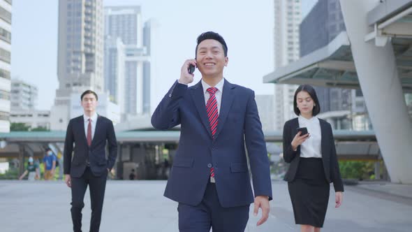 Asian manager smart businessman using smartphone in city. Telecommunication for business concept.