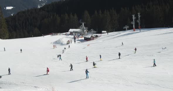 Group of People on a Low Slope Skiing in the Alps