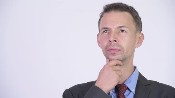 Studio Shot of Happy Businessman Smiling While Thinking