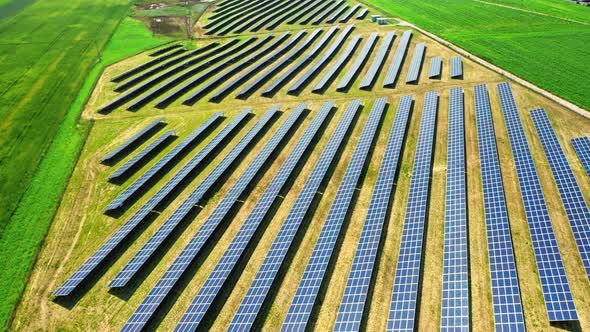 Aerial view of solar panels on green field in spring