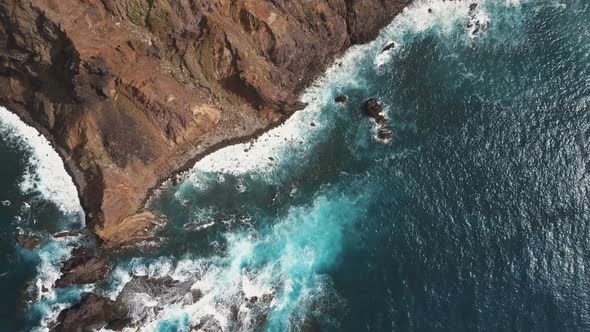 Aerial Top View of Ocean Waves Breaking on Rocks. Blue Water and White Foam on Tenerife, Canary