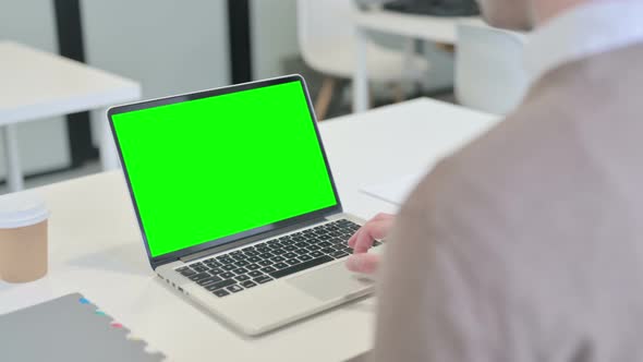 Rear View of Man Using Laptop with Open Screen