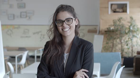 Businesswoman Standing with Crossed Arms and Smiling at Camera