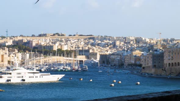 Superyacht moored in harbor of Valletta, Malta island. Pan right view