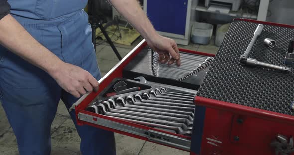 Auto Mechanic Opens A Box With Working Tools For Repair And Diagnostics Of Cars