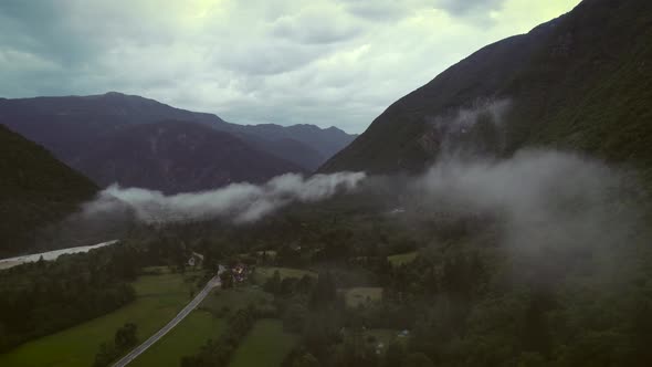 Aerial view of Soca river valley with misty clouds in full nature, Slovenia.