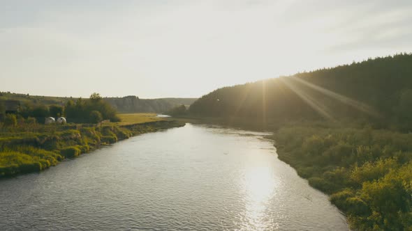 Aerial View of the River with Smooth Water and Forest on the Banks