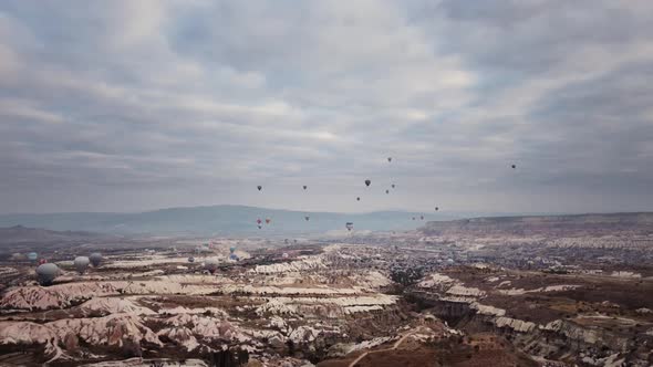 Landscape of Limestone Valley with Volcanic Formations and Lots of Air Balloons Flying in Sky