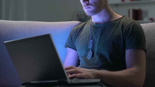 Soldier Working on Laptop at Night Sitting Sofa, Modern Technology, Cyber War