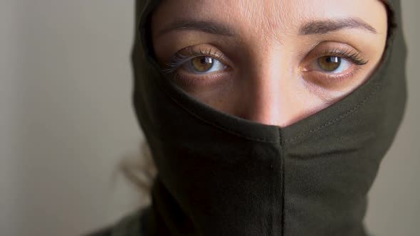 Female Portrait of Young Girl Wearing Khaki Balaclava Only Eyes are Visible Mandatory Conscription