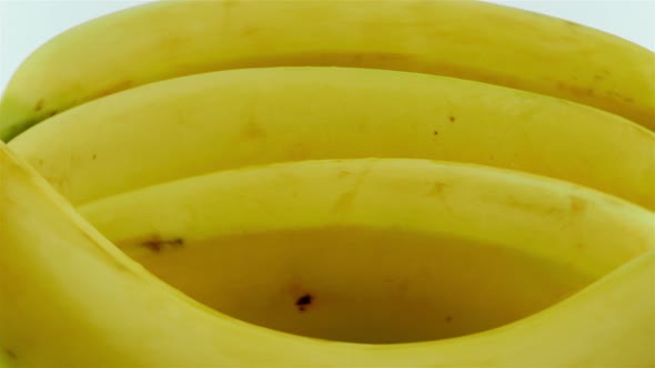 Close-up Shot of Rotating Organic Bananas - White Background