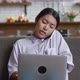 Busy Asian Business Woman Professional Talking on Phone Using Laptop Sitting on Sofa at Living Room - VideoHive Item for Sale