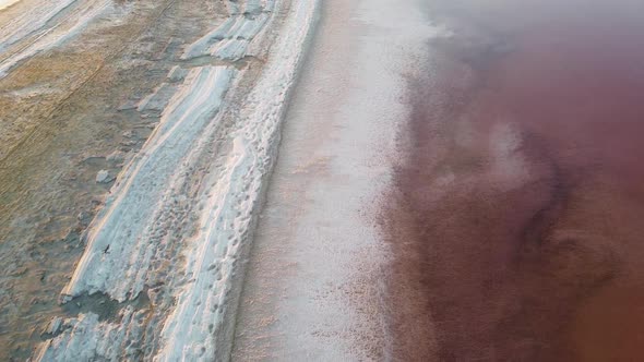 The coast is covered with salt on the lake with a pink tinge and high salt content.