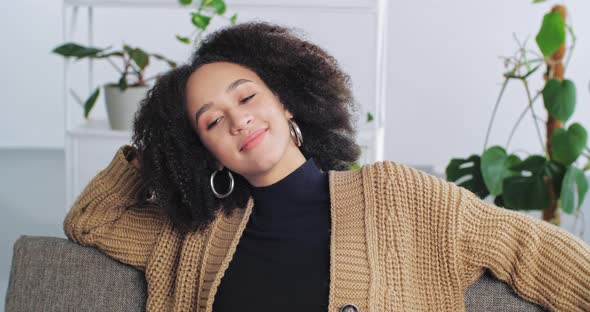 Tired Woman African American Girl with Afro Curls Hairstyle Feels Exhaustion Sits with Closed Eyes