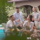 Group of happy young people cheering with cider by the pool in the garden - VideoHive Item for Sale
