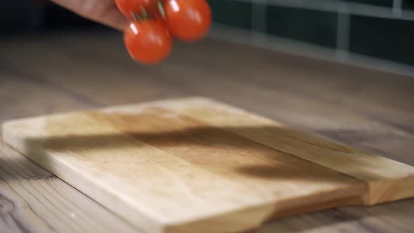 Fresh Tomatoes with Water Drops on Wooden Board