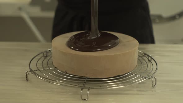 Professional chef tossing chocolate onto a cake