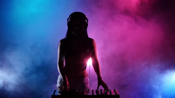 Girl Sexy DJ with Headphones Playing on Turntables. Slow Motion