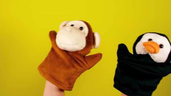 Soft Puppet Toys on Hands on Yellow Background