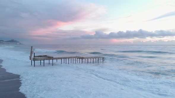 Powerful sea waves with white foam rolling on pebble sea beach