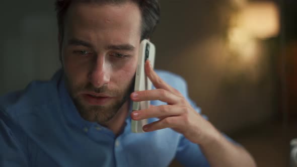 Pensive man talking by phone