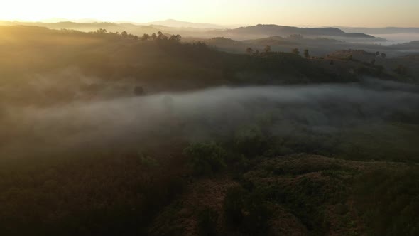 4K Aerial view flying in fog. clouds at sunset fog.