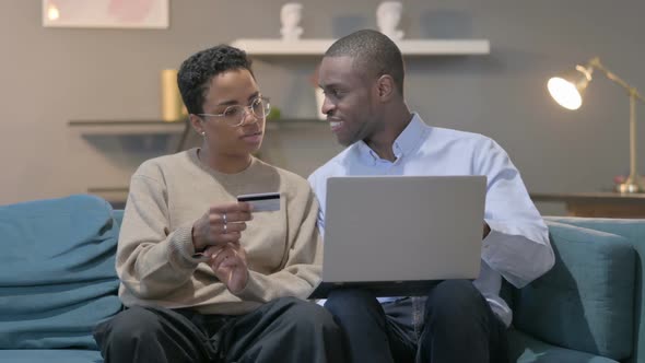 Couple Having Successful Online Shopping on Laptop on Sofa