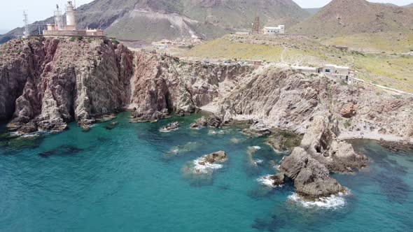 flying around a coast with steep cliffs and a lighthouse