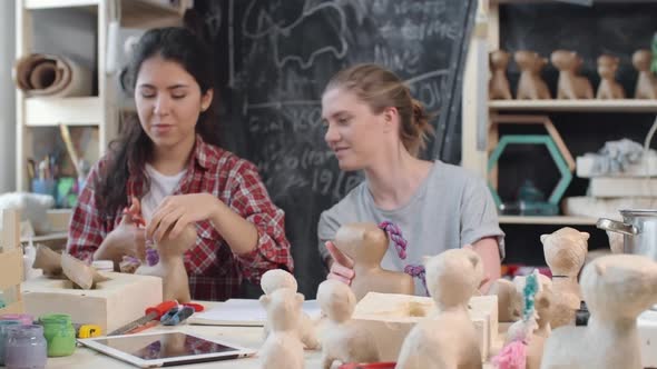 Women Making Toys with Yarn and Paper