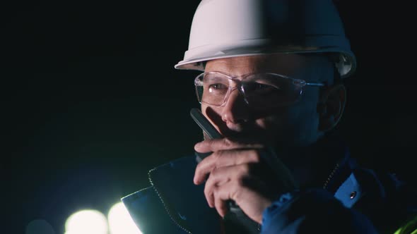 Engineer Talking on Radio at Night