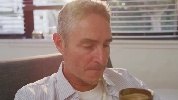 Man drinking coffee at home