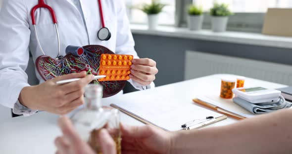 Doctor Shows Pills to Patient for Treatment of Liver