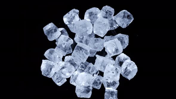 Super Slow Motion Shot of Rotating Exploded Ice Cubes and on Black at 1000Fps alt