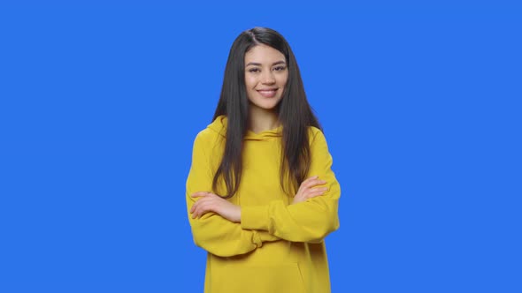 Portrait of Brunette Coquettishly Looking at Camera and Smiling