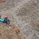 Aerial View of a Young Happy Mother Sitting on a Rock and Playing with Her Little Child. - VideoHive Item for Sale