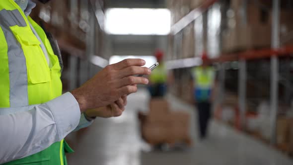 Tablet in Hands of Warehouse Employee During Work
